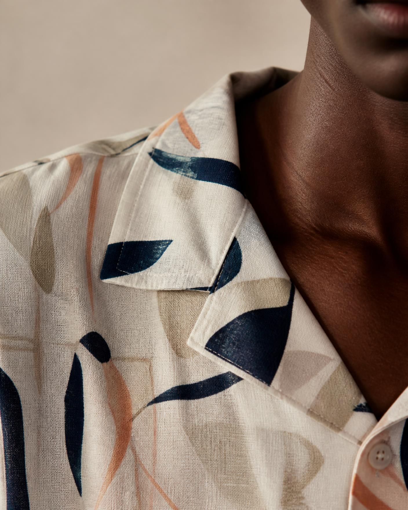 Close-up fabric detail of a printed shirt on a Nigerian model